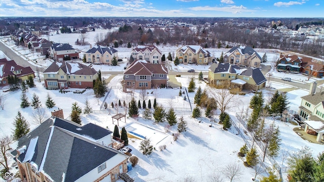 snowy aerial view with a residential view