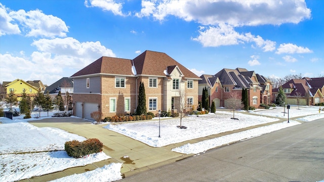 view of front of home featuring fence, a residential view, concrete driveway, an attached garage, and brick siding