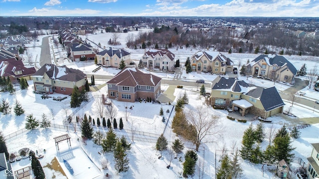 snowy aerial view featuring a residential view