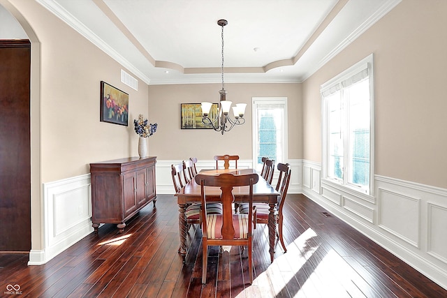 dining room featuring visible vents, an inviting chandelier, arched walkways, dark wood-type flooring, and a raised ceiling