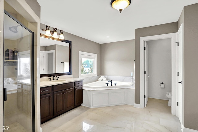 full bathroom featuring toilet, marble finish floor, a shower stall, a bath, and vanity