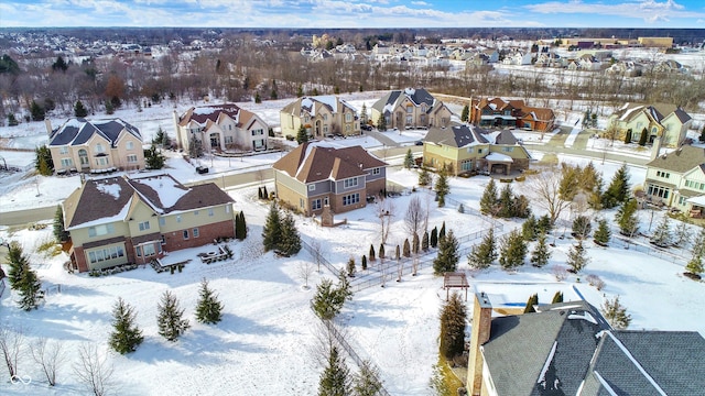 snowy aerial view featuring a residential view