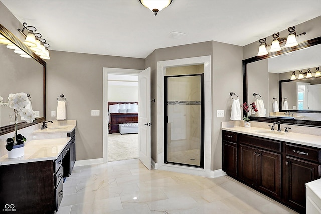 full bathroom with a shower stall, two vanities, and a sink