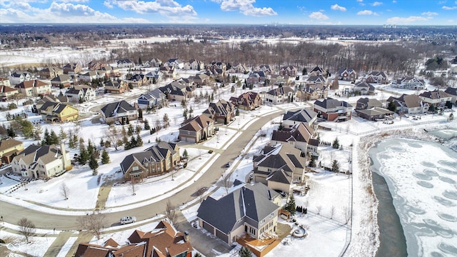 snowy aerial view with a residential view