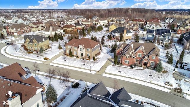 snowy aerial view featuring a residential view