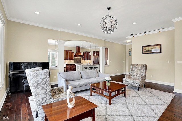 living room with dark wood-type flooring, decorative columns, crown molding, and baseboards