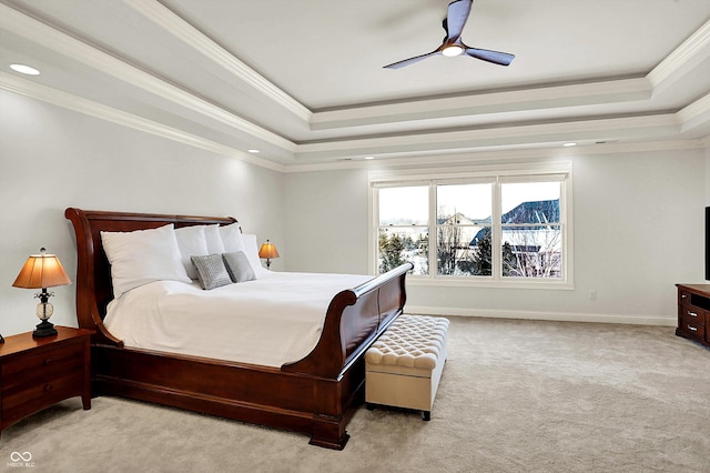 bedroom with a raised ceiling, ornamental molding, and carpet flooring