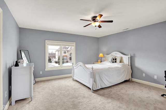 bedroom with a ceiling fan, visible vents, light colored carpet, and baseboards