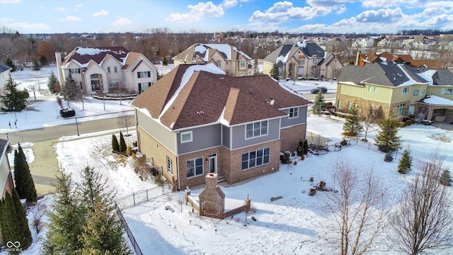 snowy aerial view featuring a residential view