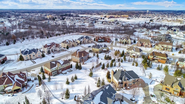 snowy aerial view featuring a residential view