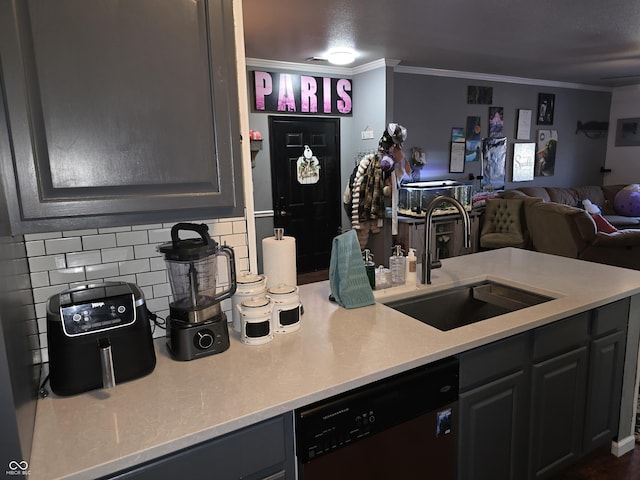 kitchen with crown molding, light countertops, open floor plan, a sink, and dishwasher