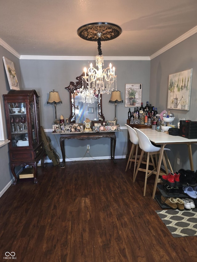 dining room with ornamental molding, wood finished floors, and baseboards