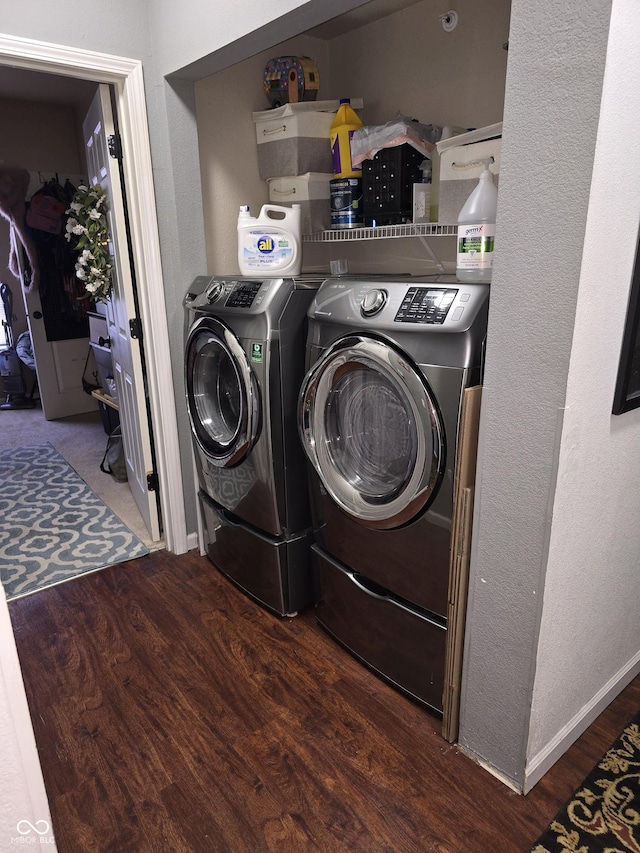 washroom with baseboards, laundry area, wood finished floors, and washer and dryer