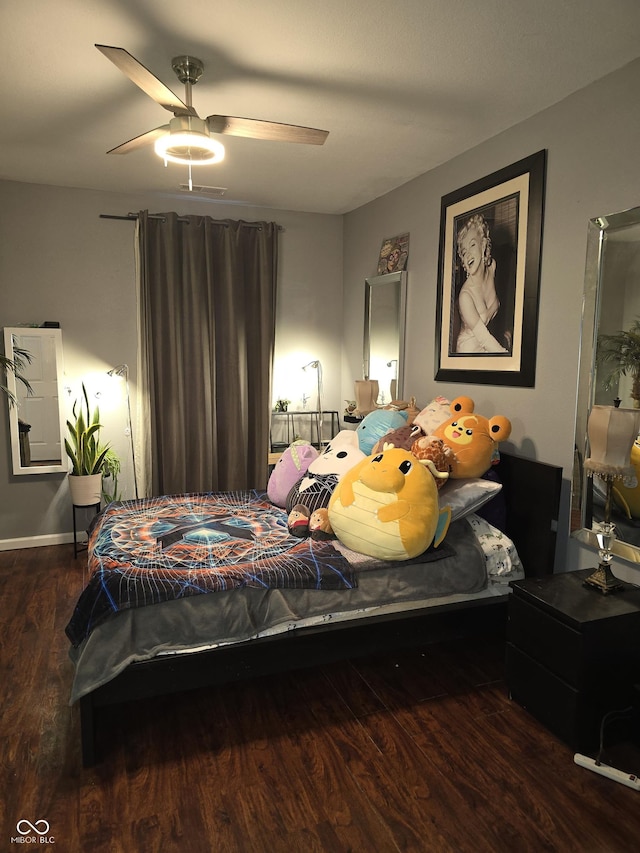 bedroom with ceiling fan, wood finished floors, and visible vents