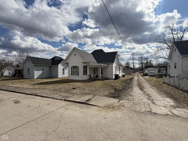 view of front of property with driveway and a shingled roof