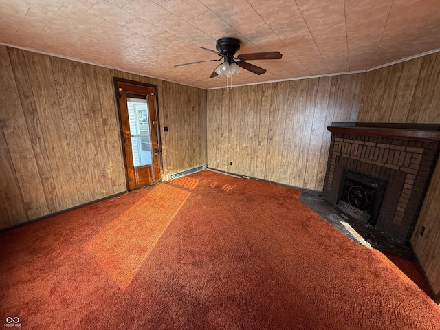 unfurnished living room featuring a baseboard radiator, wooden walls, carpet, and a fireplace