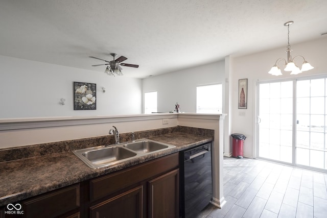 kitchen featuring black dishwasher, dark countertops, dark brown cabinets, pendant lighting, and a sink