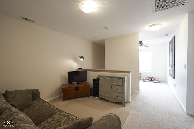 living room with light carpet, baseboards, and visible vents