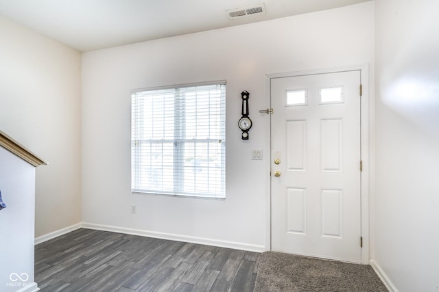 entrance foyer featuring dark wood-type flooring, visible vents, and baseboards