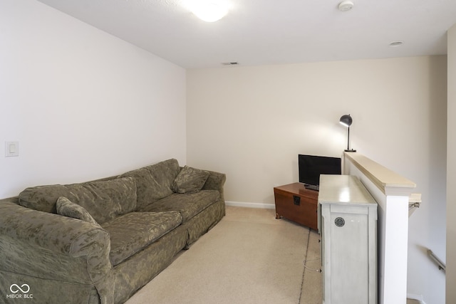 living area featuring light colored carpet, visible vents, and baseboards