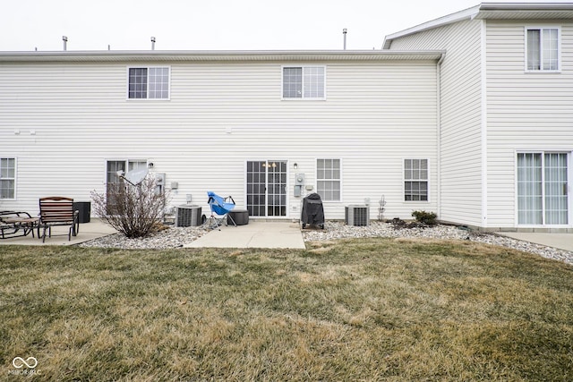 back of property featuring a patio, central AC unit, and a lawn