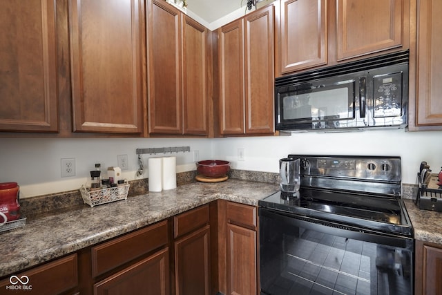 kitchen with black appliances and dark countertops