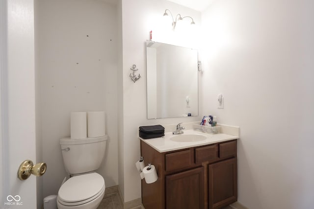 bathroom featuring toilet and vanity