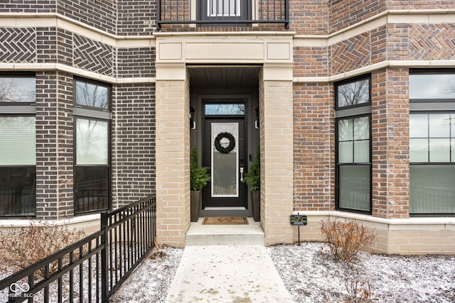 doorway to property with brick siding