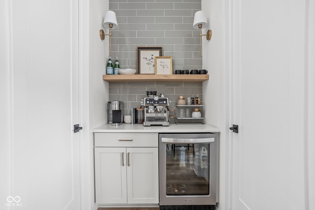 bar featuring a bar, wine cooler, and tasteful backsplash