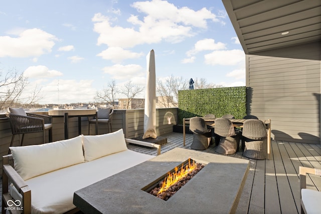 wooden deck with an outdoor living space with a fire pit