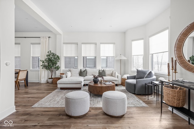 living area with wood finished floors and baseboards