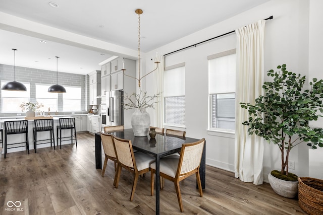 dining area with wood finished floors