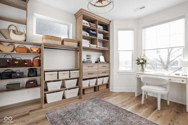 walk in closet featuring wood finished floors and visible vents