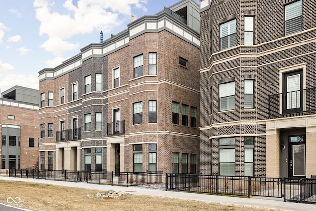 view of building exterior with fence