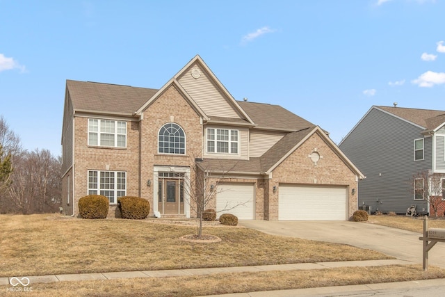 traditional-style home with brick siding, a shingled roof, concrete driveway, a garage, and a front lawn