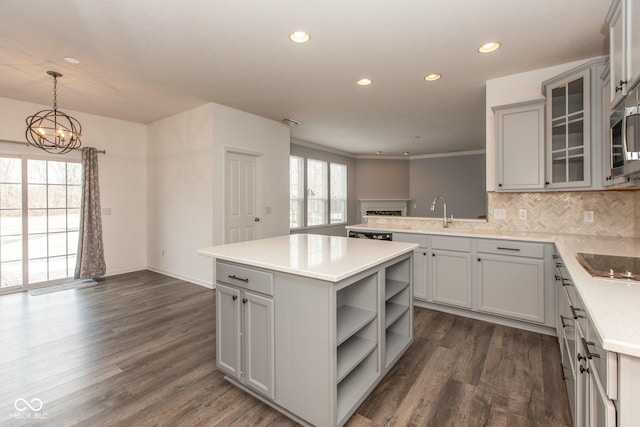 kitchen with open floor plan, light countertops, dark wood-type flooring, and gray cabinetry