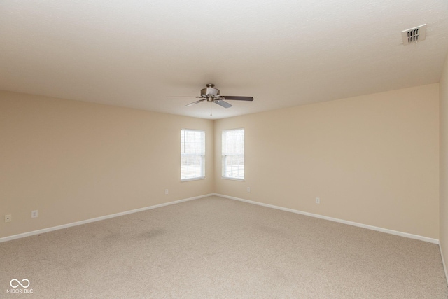 unfurnished room featuring a ceiling fan, carpet, visible vents, and baseboards