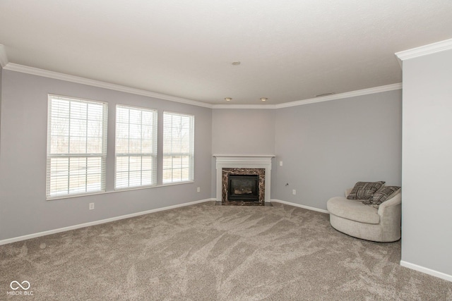 unfurnished living room featuring carpet flooring, crown molding, baseboards, and a premium fireplace