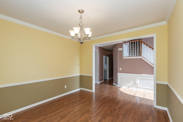 unfurnished room featuring wood finished floors, baseboards, stairs, ornamental molding, and an inviting chandelier