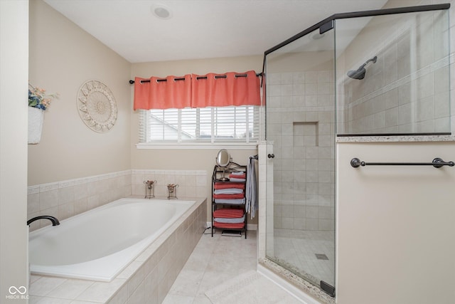 full bath featuring a stall shower, tile patterned flooring, and a bath