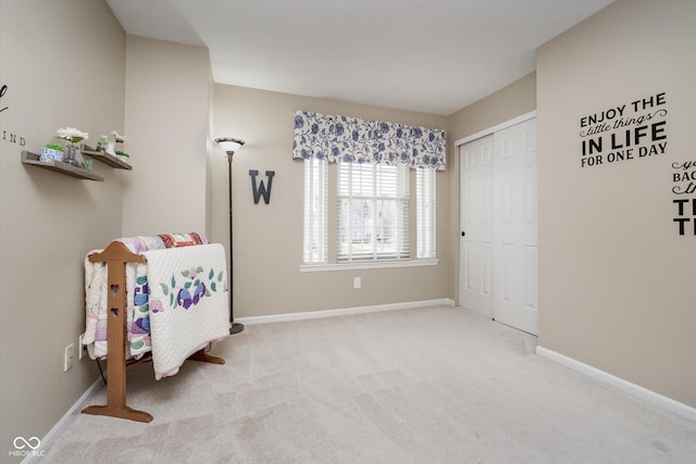 bedroom with carpet floors, baseboards, and a closet