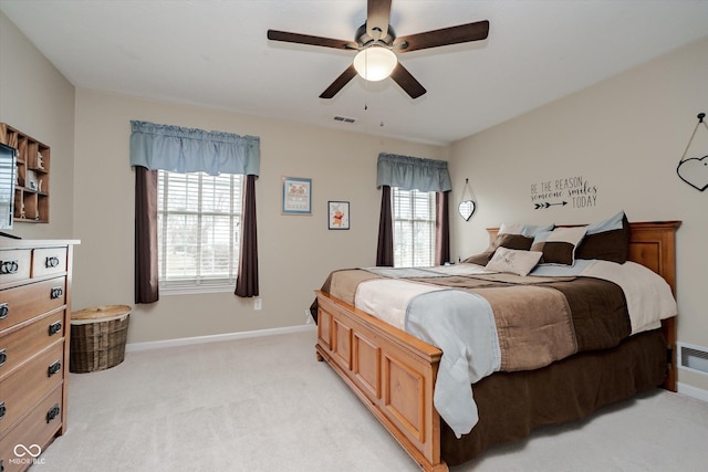 bedroom featuring light carpet, ceiling fan, visible vents, and baseboards