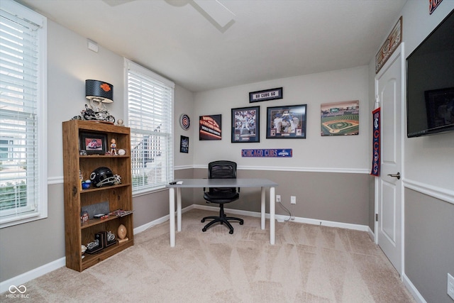 carpeted office featuring baseboards