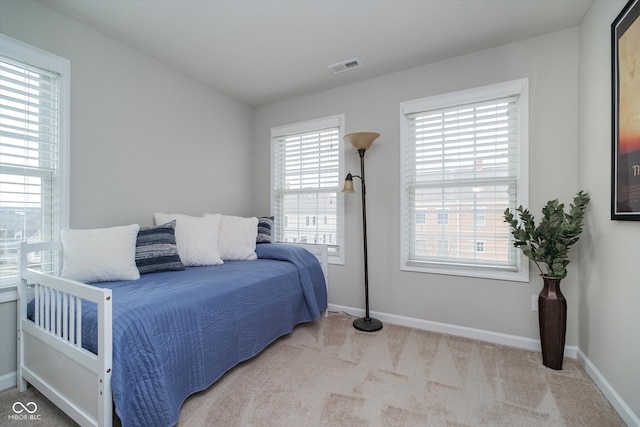 bedroom with visible vents, carpet flooring, and baseboards