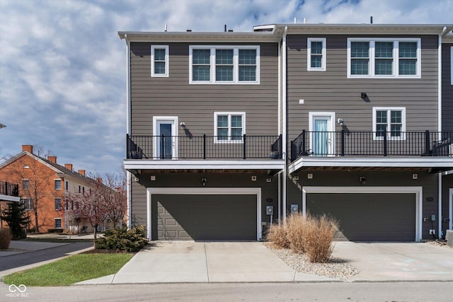 rear view of property featuring an attached garage and driveway