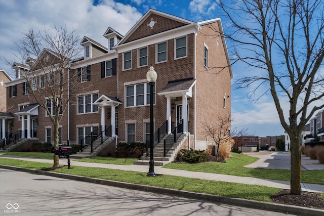 view of front facade with a residential view and brick siding