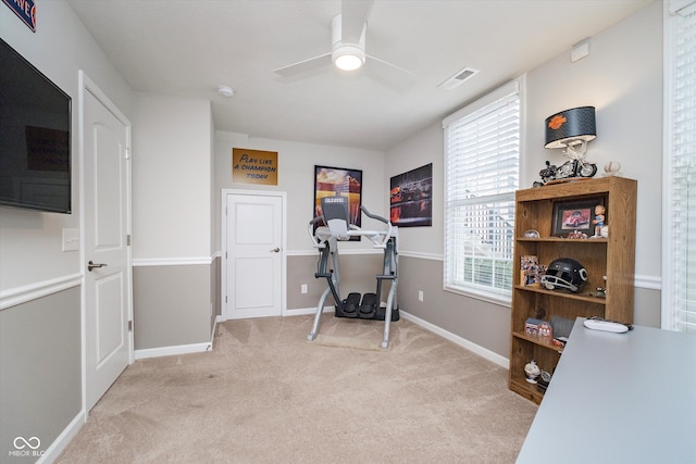 carpeted office featuring a ceiling fan, baseboards, and visible vents