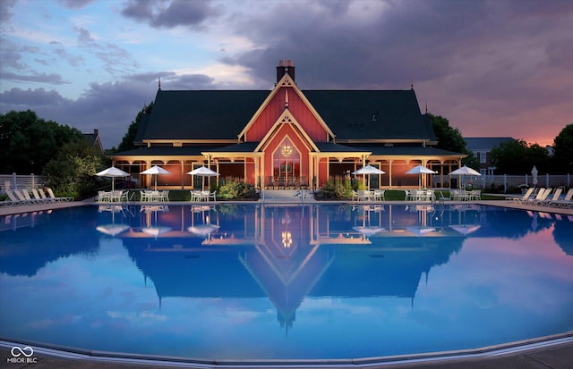 pool with a patio area and fence