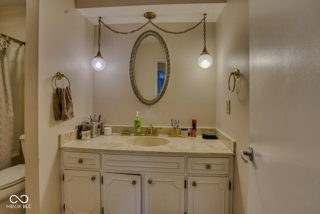 full bath featuring vanity and toilet