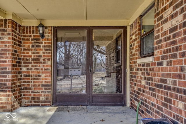 view of exterior entry with brick siding